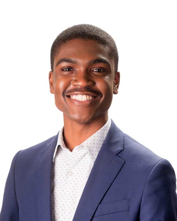 Portrait of Gregory Hamilton Jr. in a navy blazer